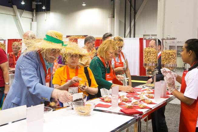 Conventioneers grab samples of Post Shredded Wheat during the 2013 AARP Convention on Thursday, May 30, 2013.